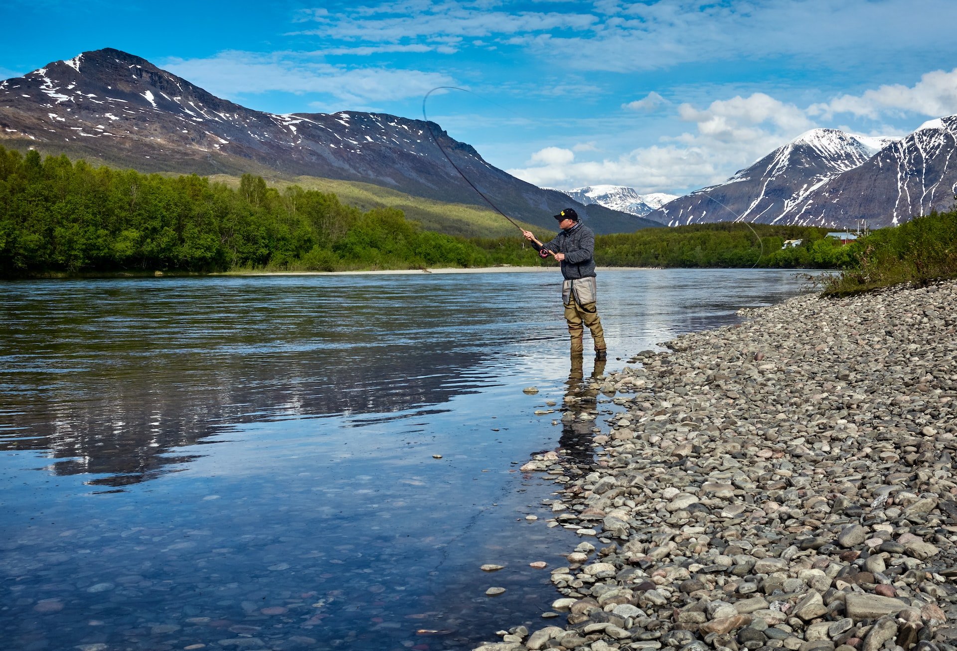 A man fishing at a lake.